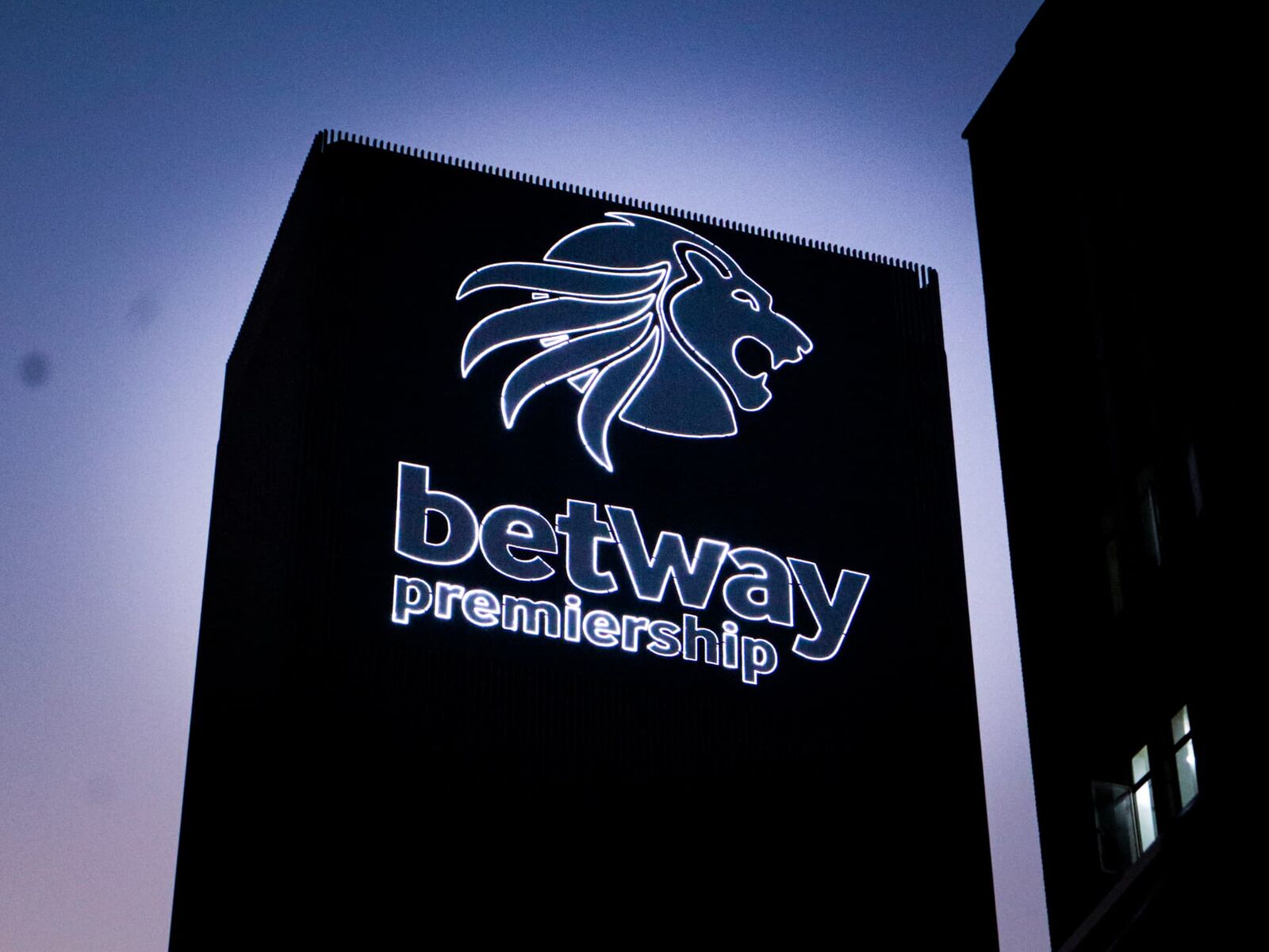 Illuminated Betway building sign at night