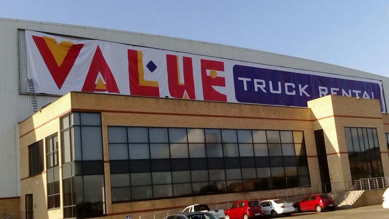 Large PVC banner across a warehouse facade